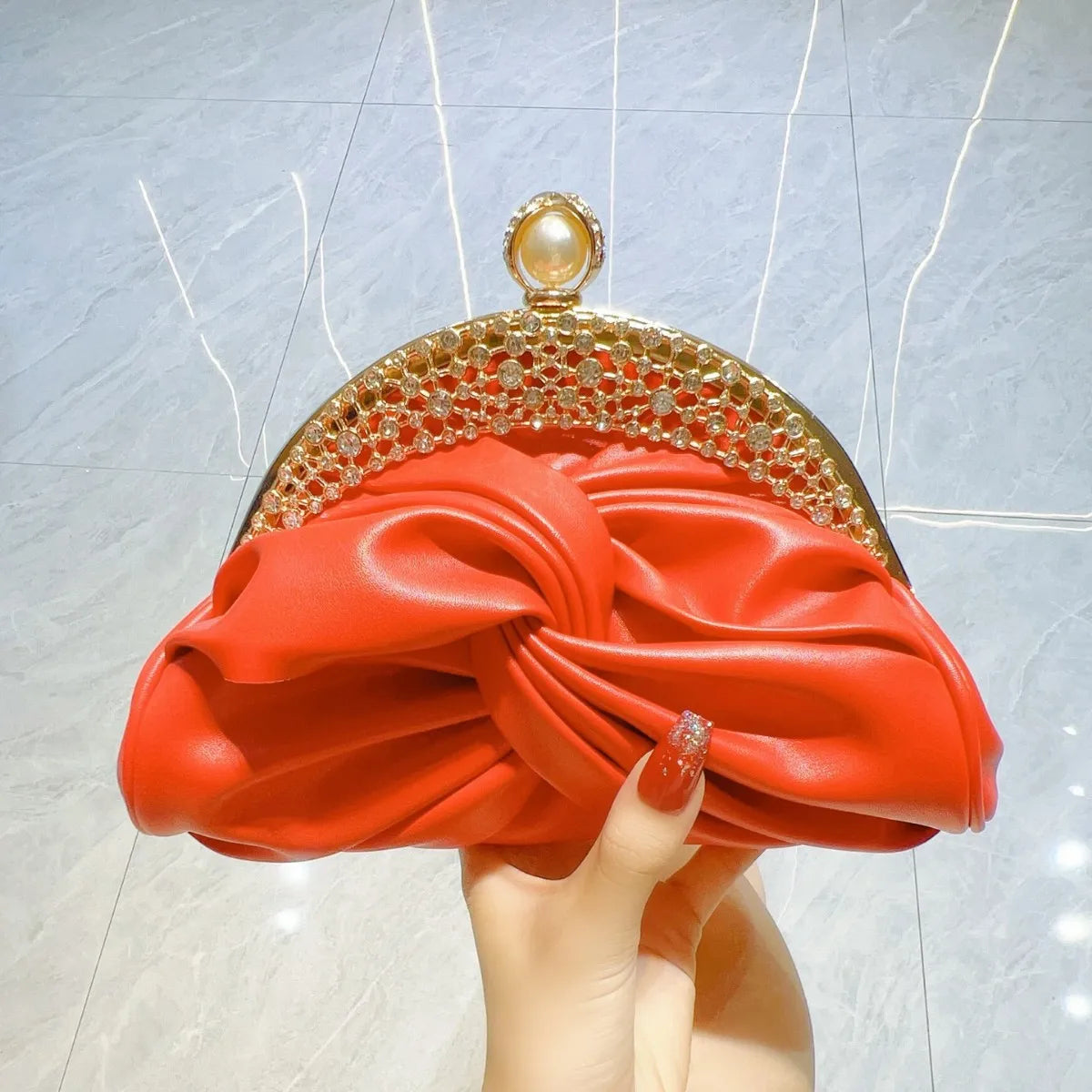 Red satin evening clutch with crystal-embellished gold-tone frame and chain