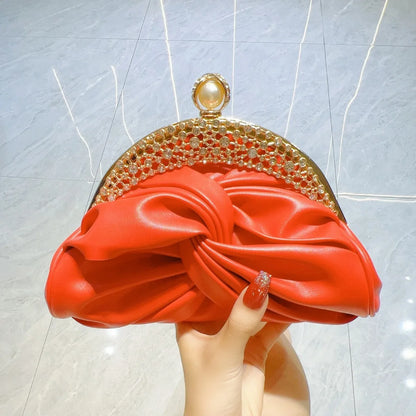 Red satin evening clutch with crystal-embellished gold-tone frame and chain