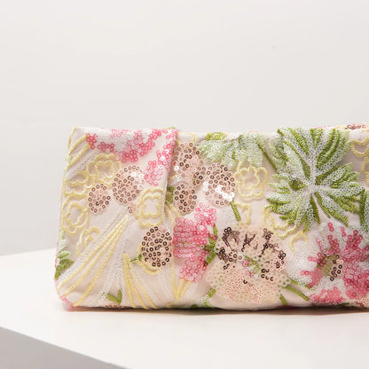 Clutch bag with sequin floral embroidery on pastel pink fabric