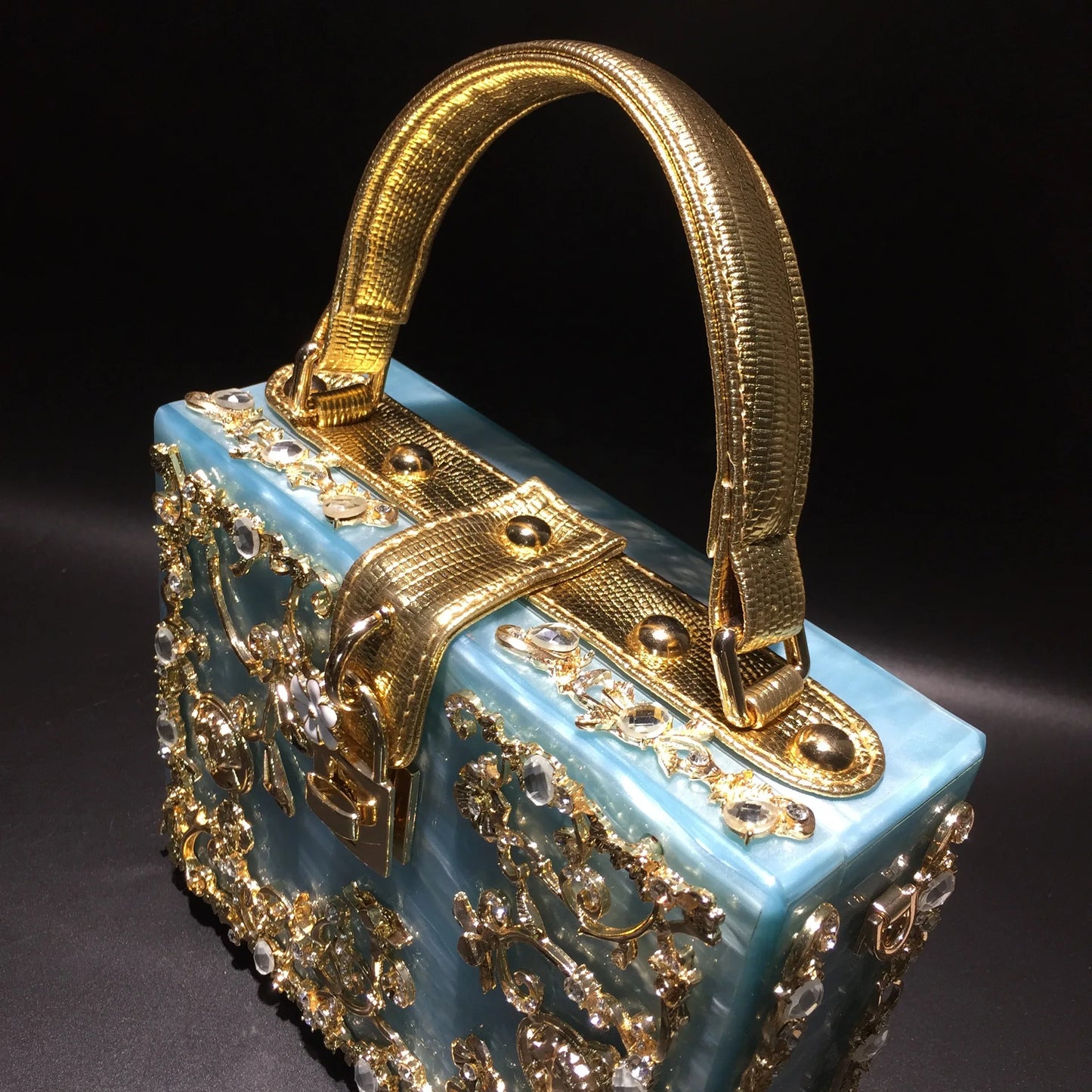 Edenista acrylic evening bag with blue body and gold rhinestone-encrusted frame handle, luxury wedding clutch