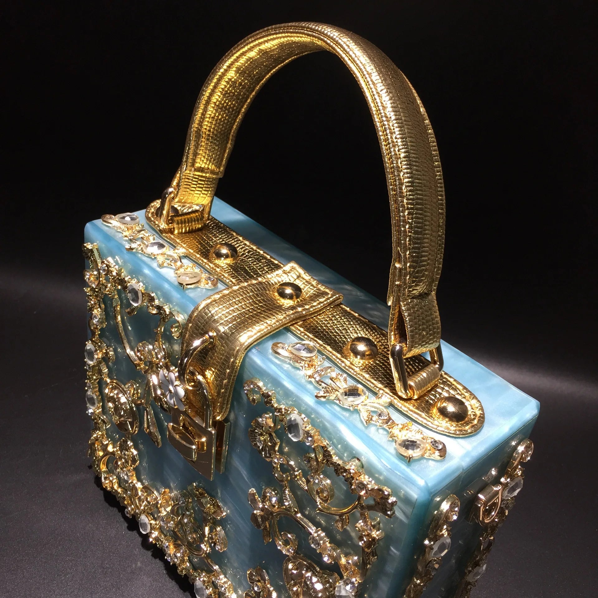 Edenista acrylic evening bag with blue body and gold rhinestone-encrusted frame handle, luxury wedding clutch