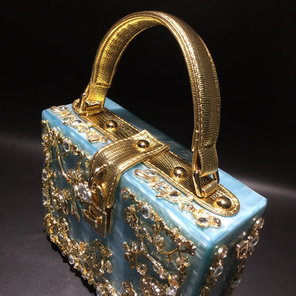 Edenista acrylic evening bag with blue body and gold rhinestone-encrusted frame handle, luxury wedding clutch