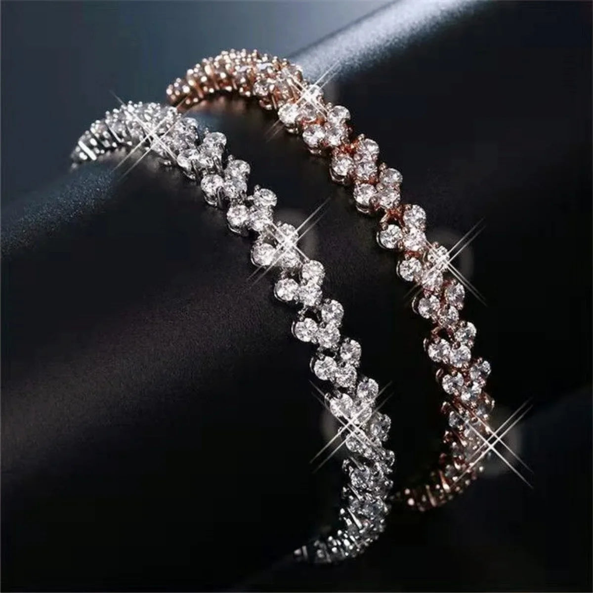 Crystal geometric chain bracelets by Edenista, two rhinestone bangles in silver and rose gold tones.