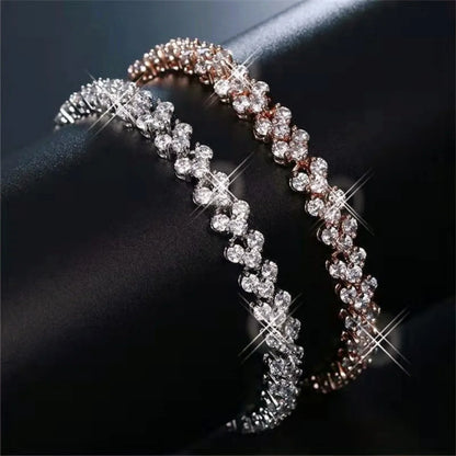 Crystal geometric chain bracelets by Edenista, two rhinestone bangles in silver and rose gold tones.