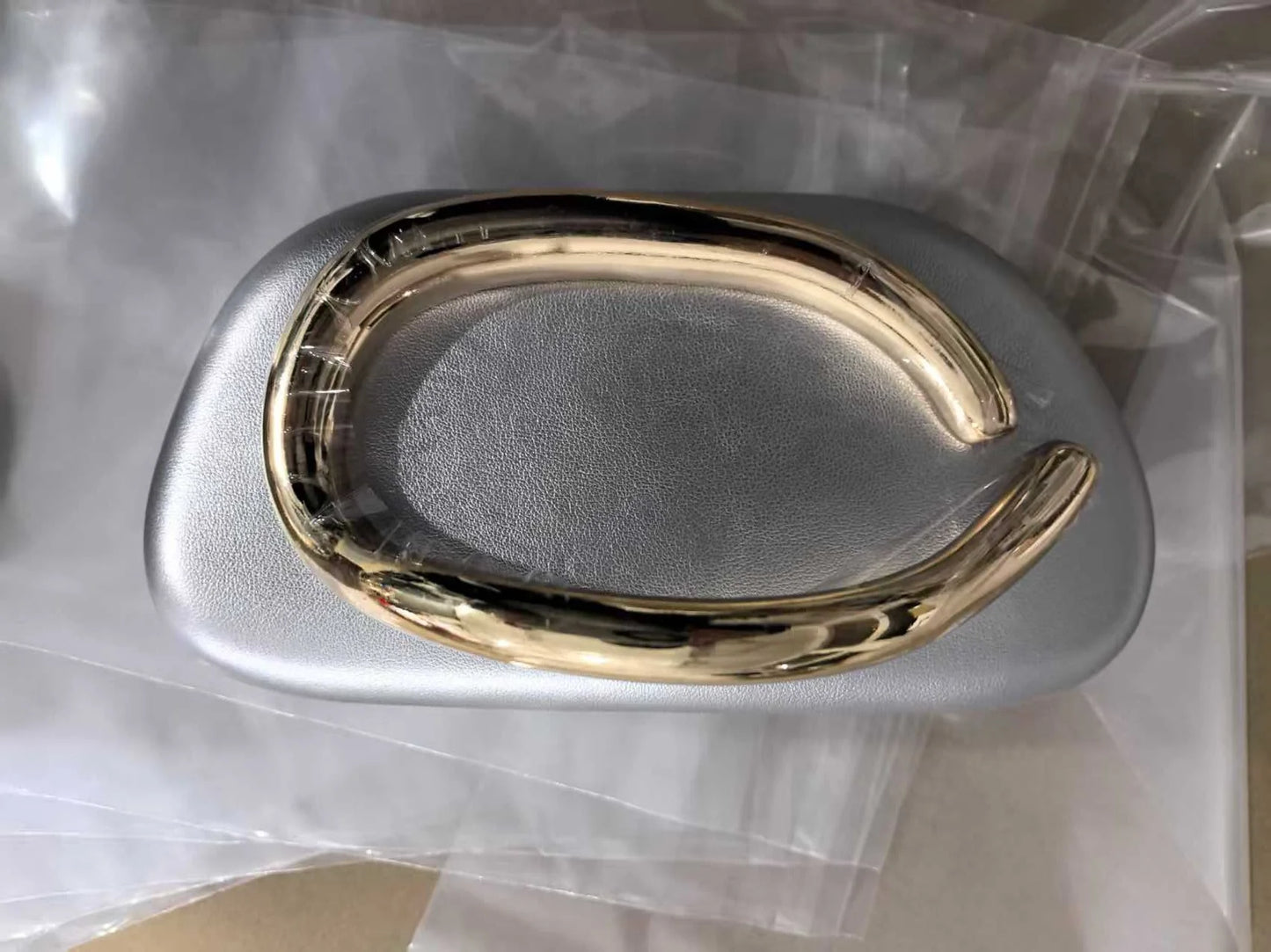 Gold metal-frame box clutch bag with metallic silver body, evening handbag.