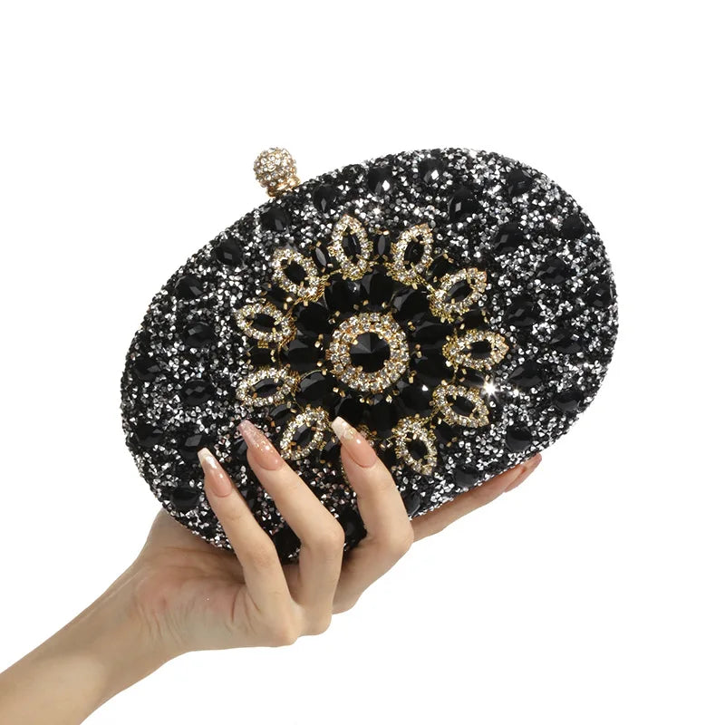 Luxury evening clutch bag, black glitter with a gold crystal floral centerpiece