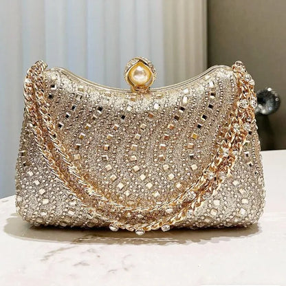 Gold-and-silver-tone rhinestone clutch with pearl clasp and chain strap, evening bag.