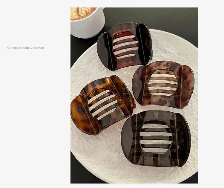 Crab hair clips set: four flat claw clips in black and tortoiseshell with beige striped centers