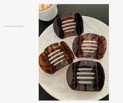 Crab hair clips set: four flat claw clips in black and tortoiseshell with beige striped centers
