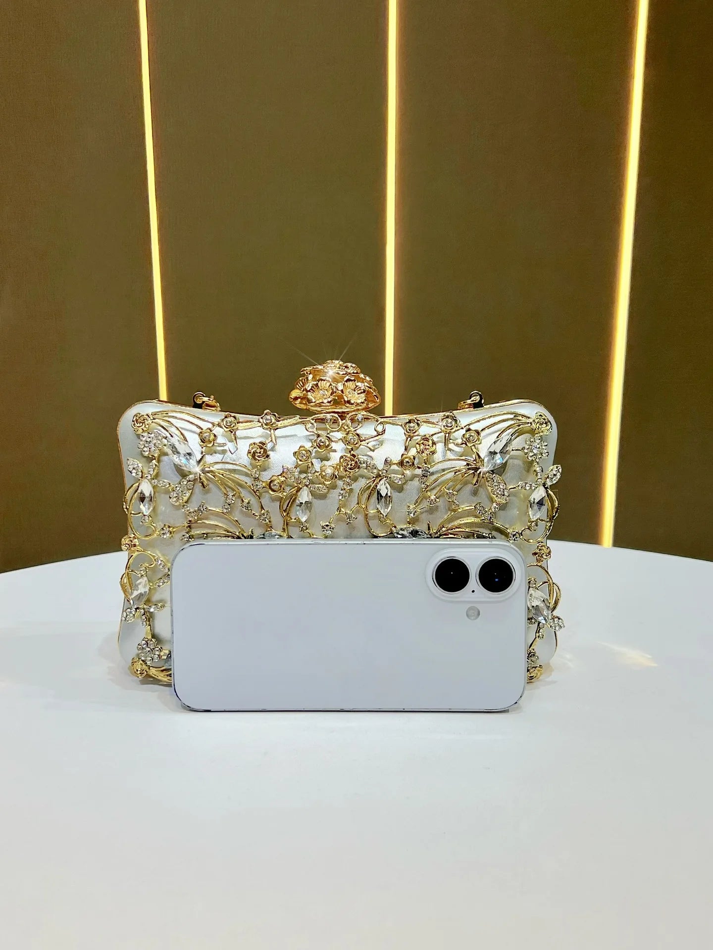 White crystal-embellished banquet clutch with gold-tone floral embroidery for evening wear