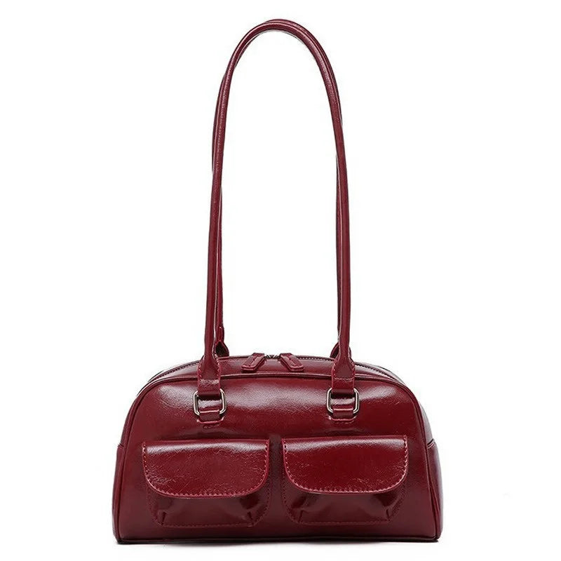 Bowling bag in burgundy with two front pockets and long dual shoulder straps