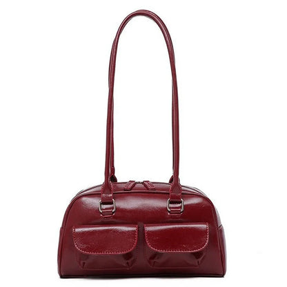 Bowling bag in burgundy with two front pockets and long dual shoulder straps