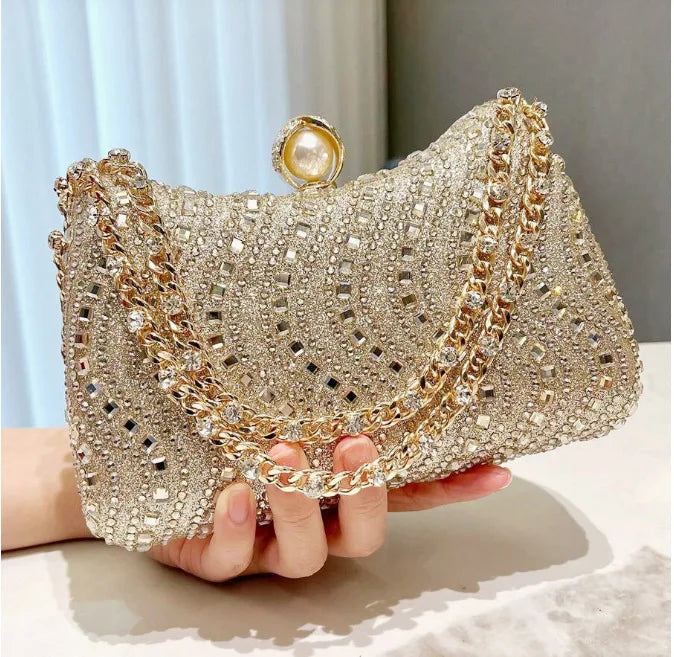 Edenista rhinestone evening clutch, gold-tone crystal bag with pearl clasp and chain strap.