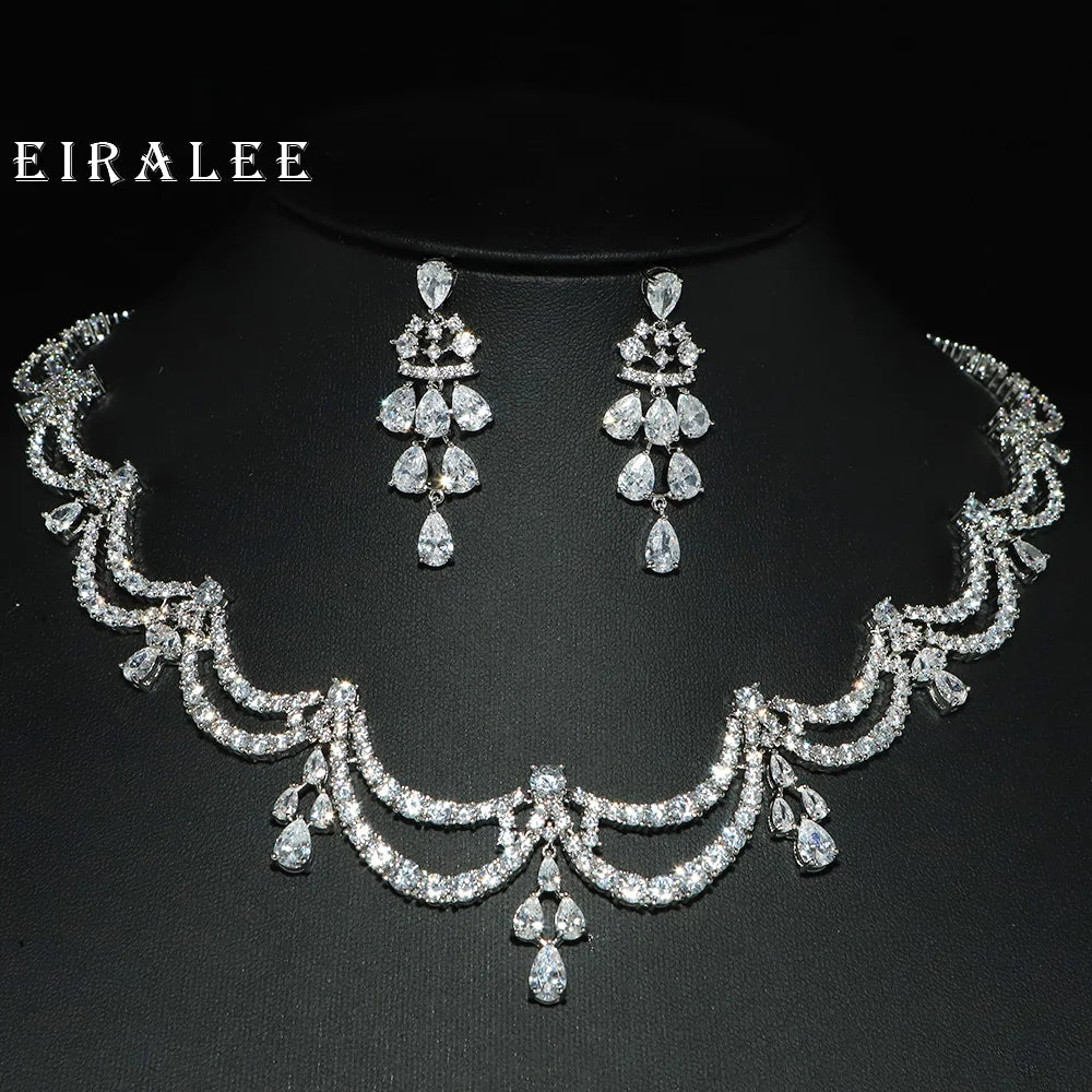 Silver jewelry set with necklace and earrings on a black background, featuring the brand 'EIRALEE'.