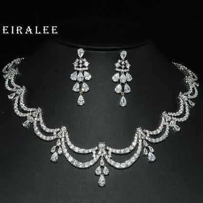 Silver jewelry set with necklace and earrings on a black background, featuring the brand 'EIRALEE'.