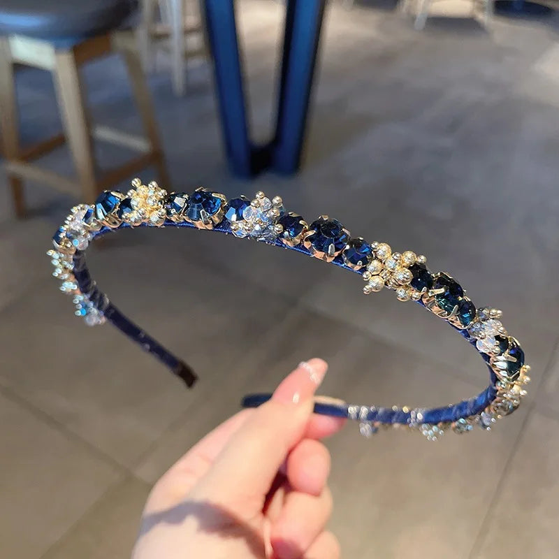 Edenista rhinestone headband with dark blue and clear crystals on a blue band
