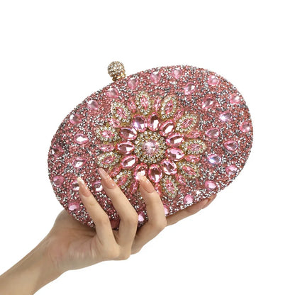 Pink round crystal-embellished clutch for evening wear with floral design and gold-tone accents