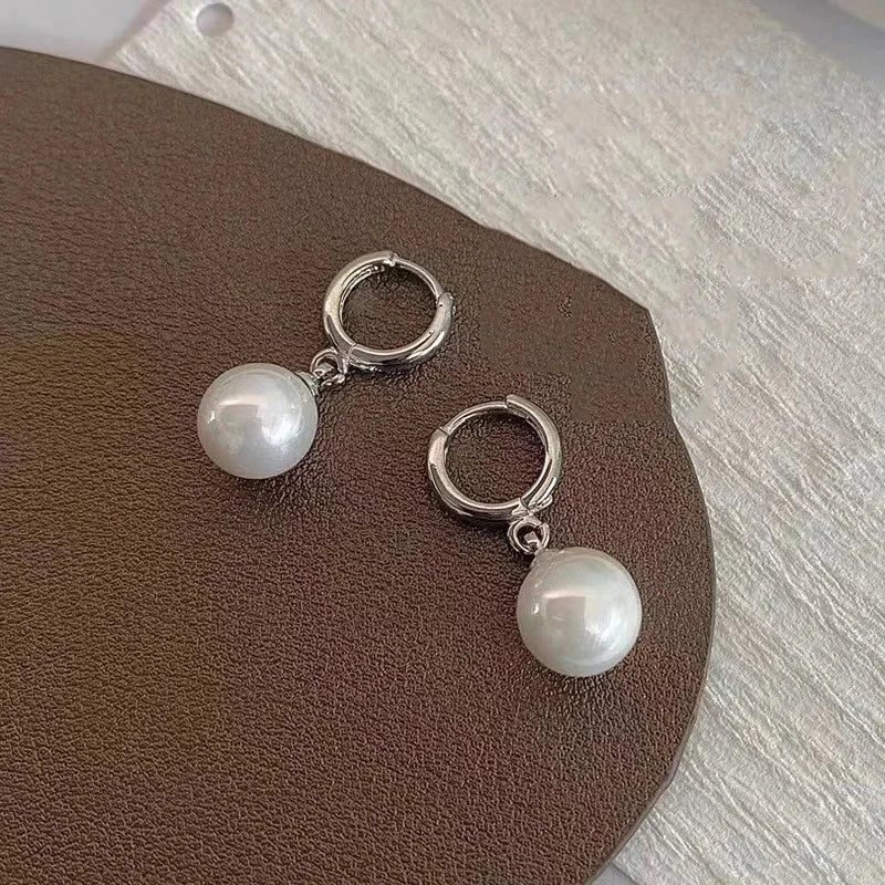 Pair of silver hoop earrings with pearl drops for women, party jewelry