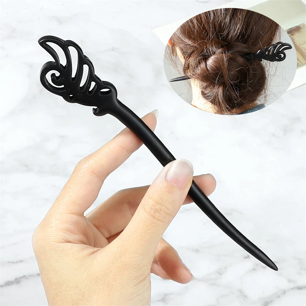 Hair pin with ornate cutout top, black plastic shaft, Chinese ethnic style design