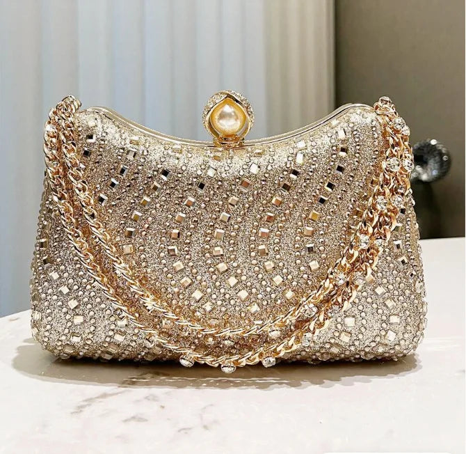 Small gold-toned rhinestone evening clutch with pearl clasp and chain strap