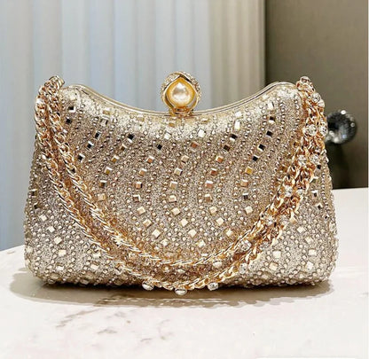 Small gold-toned rhinestone evening clutch with pearl clasp and chain strap