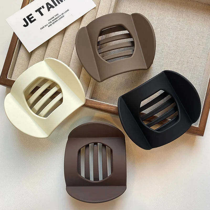Flat claw hair clips, five-pack in cream, taupe, black and brown, displayed together