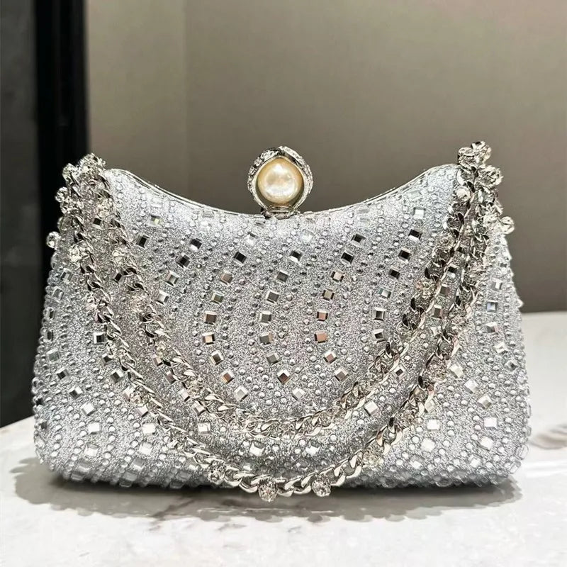 Evening clutch with silver rhinestones, pearl-top clasp, and double chain strap