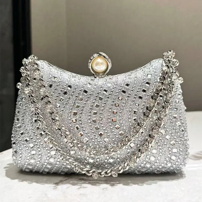 Evening clutch with silver rhinestones, pearl-top clasp, and double chain strap