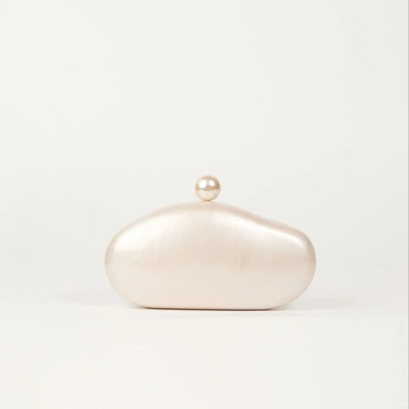 Shell clutch bag by Edenista in ivory pearl acrylic with pearl knob