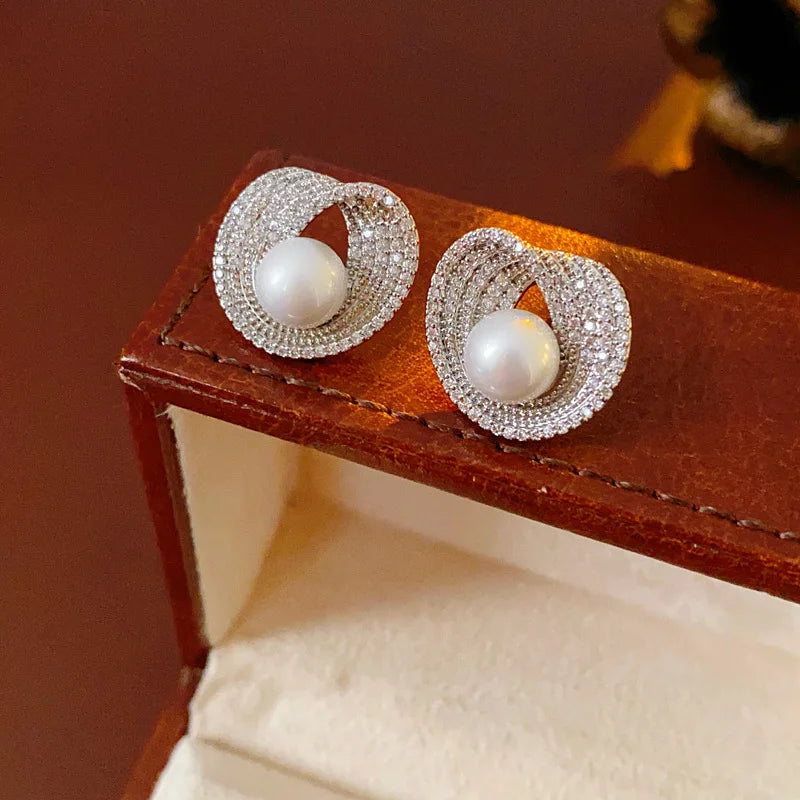 Pair of zircon round pearl earrings with pave halos and white central pearls