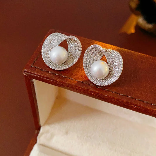 Pair of zircon round pearl earrings with pave halos and white central pearls