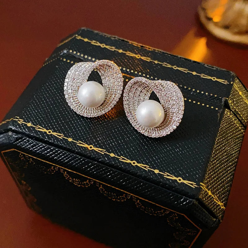 Edenista pair of zircon round pearl stud earrings with pavé halos, silver-tone setting