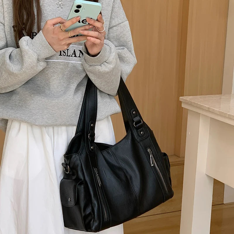 Women Vintage Edgy Black Leather Tote Bag with multiple pockets and dual shoulder straps