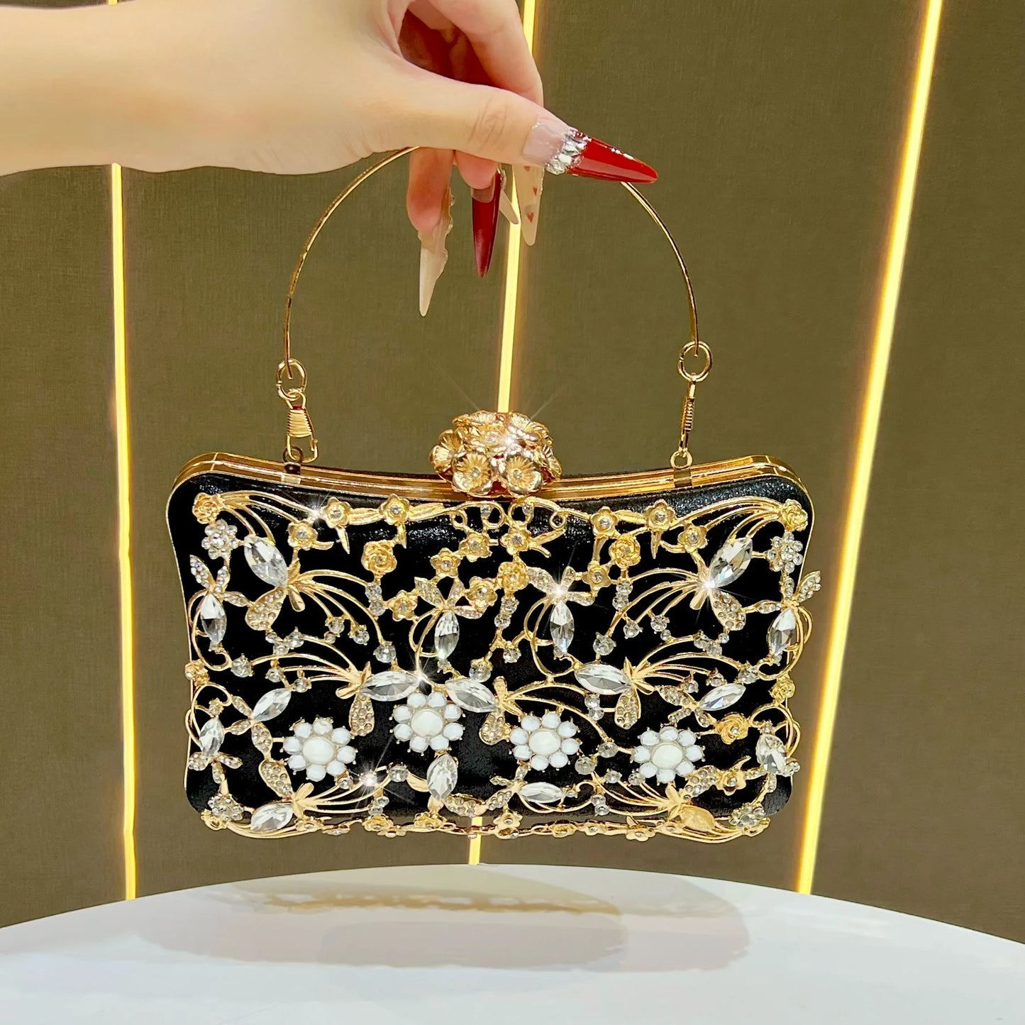 Banquet bag in black enamel with gold floral crystal embellishments and a gold frame