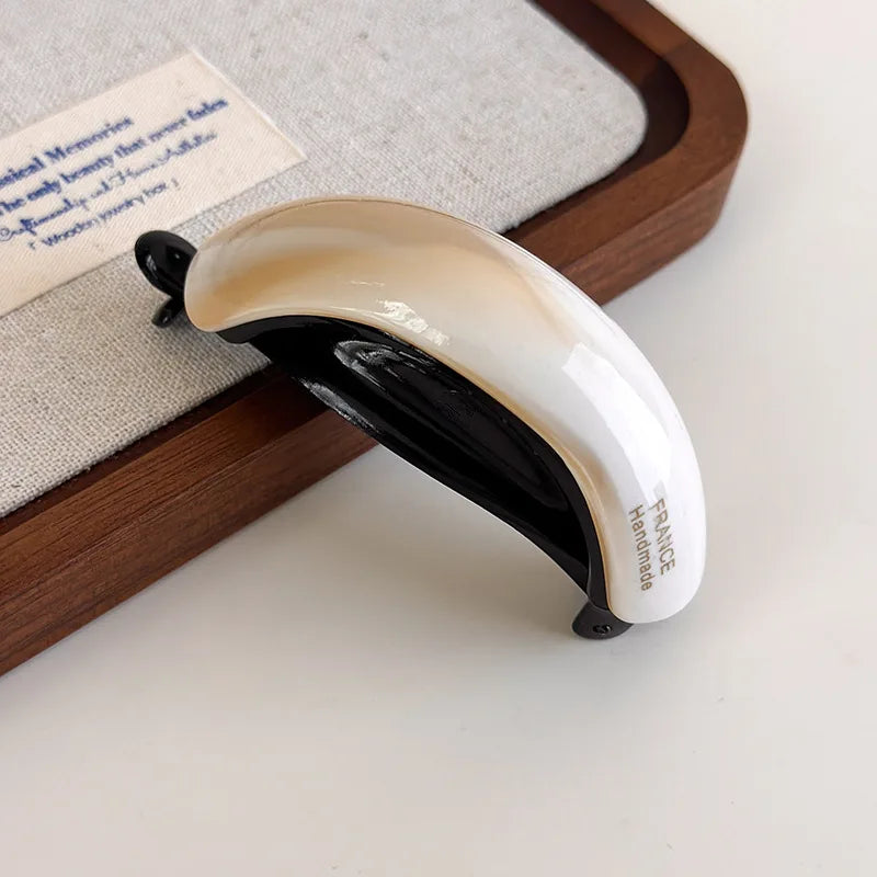 Edenista retro acetate hair clip, cream and black curved buckle design for high ponytail styling