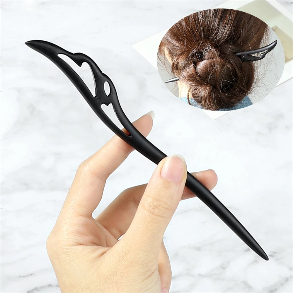 Black Chinese ethnic style hair stick with decorative cutouts for securing a bun