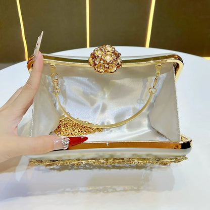 Gold banquet clutch with diamond floral clasp by Edenista, gold chain strap and white satin lining