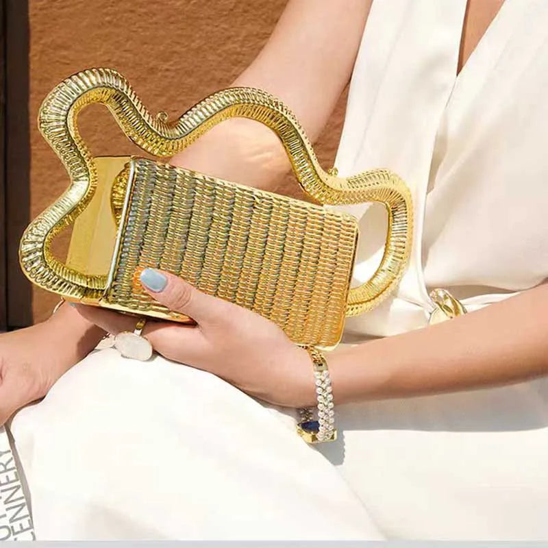 Gold woven clutch purse with oversized wavy metallic handle for evening events