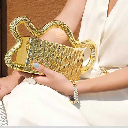 Gold woven clutch purse with oversized wavy metallic handle for evening events