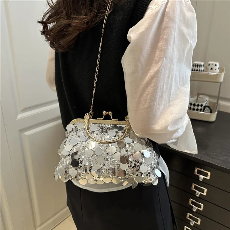 Elegant sequined evening shoulder bag with gold frame and chain, silver circular sequins.