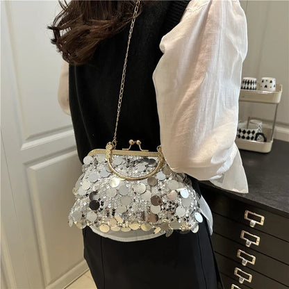 Elegant sequined evening shoulder bag with gold frame and chain, silver circular sequins.