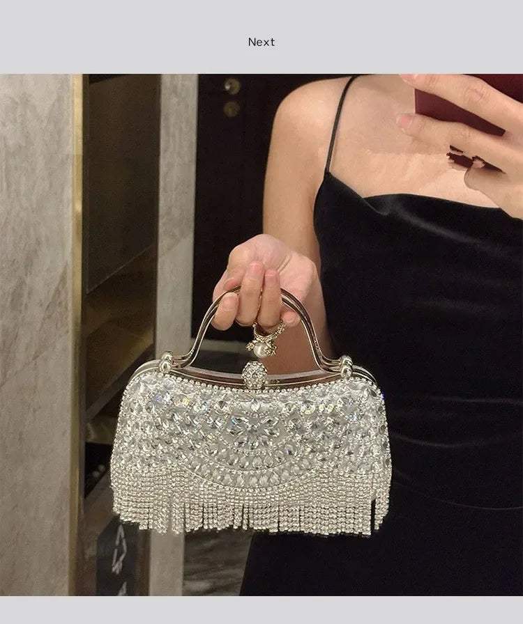 Diamond evening clutch bag with silver rhinestones and fringe tassel, held by a woman in a black dress