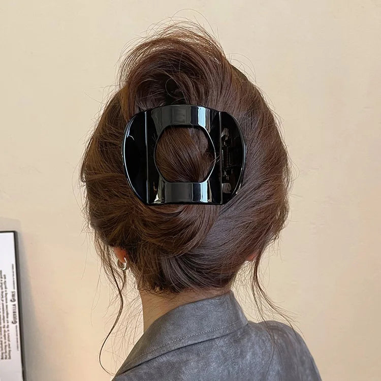 Edenista black crab hair clip, glossy square plastic claw-style accessory worn in a neat bun to secure hair