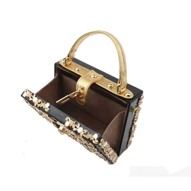 Edenista acrylic evening clutch with gold frame and rhinestone trim, black body, gold top handle