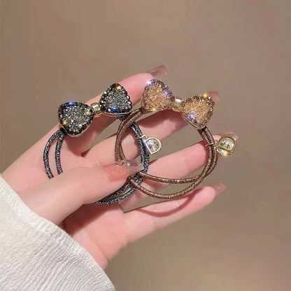 Fashion rhinestone bow scrunchies by Edenista; 2 elastic hair ties with black and rose-gold glitter bows