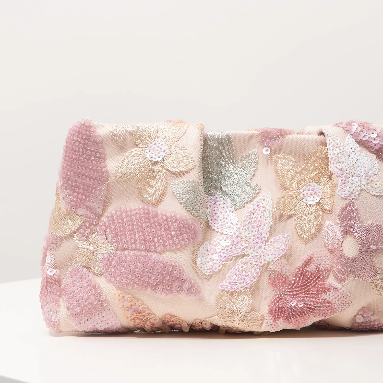 Clutch bag with pink sheer fabric and pink, gold, and silver sequin floral embroidery