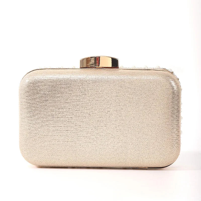 Edenista pearl evening bag clutch in champagne beaded fabric with gold-tone top clasp and long chain.
