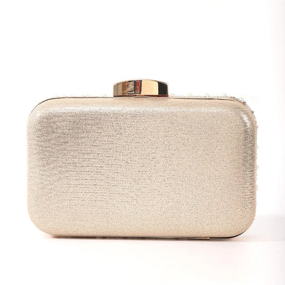 Edenista pearl evening bag clutch in champagne beaded fabric with gold-tone top clasp and long chain.