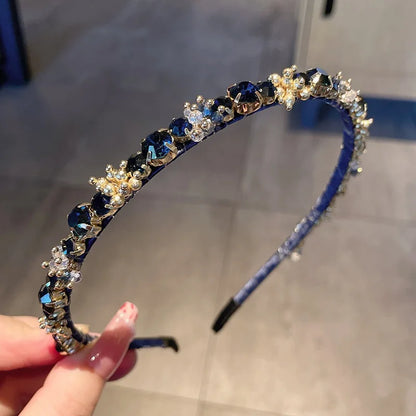 Edenista blue rhinestone headband for women, crystal-studded.