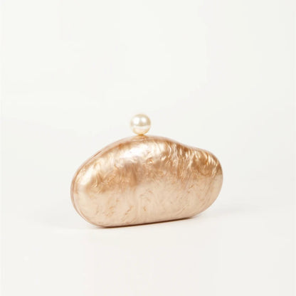 Shell clutch bag in rose-gold acrylic with a pearl top clasp